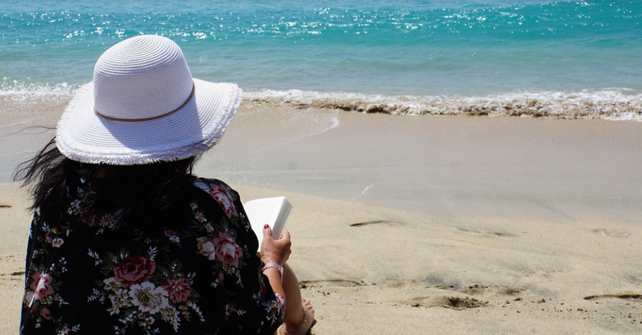 woman reading on beach
