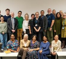 A big group of people standing inside one of the lecture rooms within the education centre.