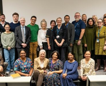 A big group of people standing inside one of the lecture rooms within the education centre.