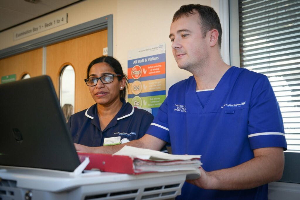 Staff on ward at laptop